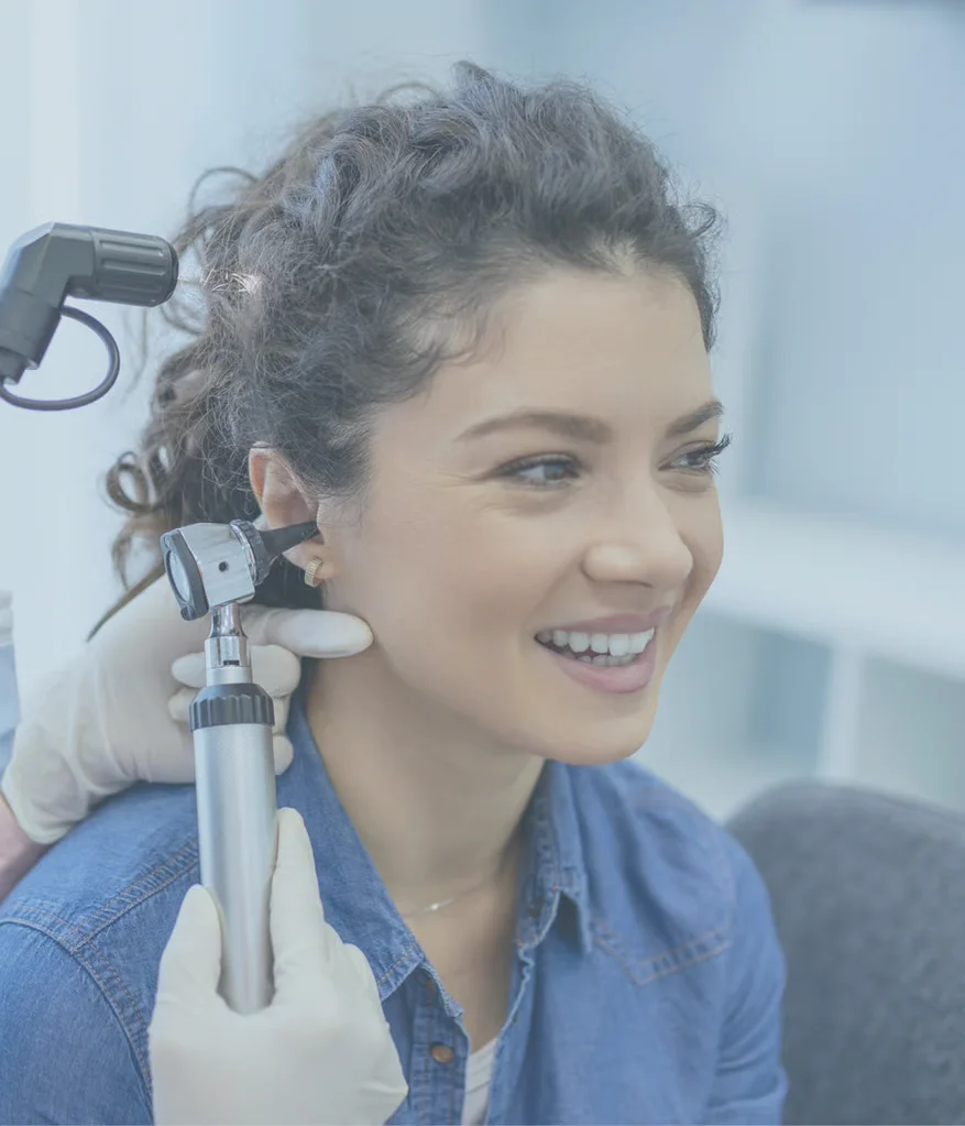 Doctor with anatomical ear model